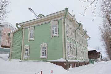 Vintage wooden house with ornamental carved windows, frames in Pushkin Street, 38, Tomsk city,...