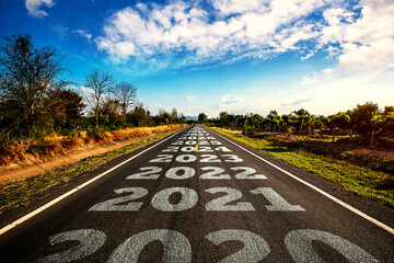2020-2030 written on highway road in the middle of empty asphalt road and beautiful blue sky. Concept for vision 2020-2030.	 - obrazy, fototapety, plakaty
