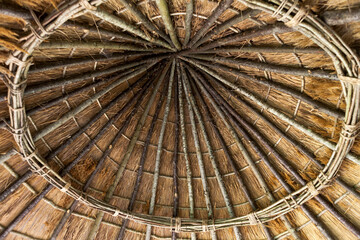 The interior of a simple thatched roof on a roundhouse in the Water Gardens, Arundel Castle gardens, Arundel, West Sussex, England, UK