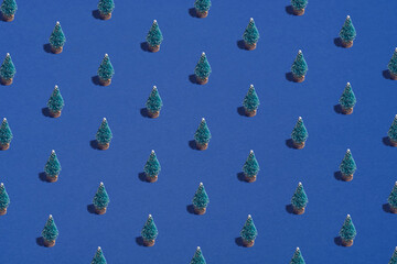 Pattern background of Christmas trees on blue. Christmas, winter holidays, New Year concept.