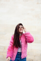 young cute girl teenager in pink fur coat gesturing hanging around outdoor , lifestyle people concept