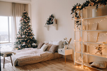 Cozy bedroom in light warm colors with winter Christmas decorations.