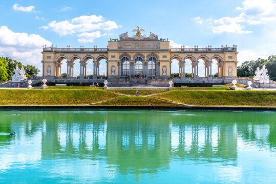 VIENNA, AUSTRIA - 23 JULY, 2019: The Gloriette in Schonbrunn Palace Gardens, Vienna, Austria. Front view and water reflection