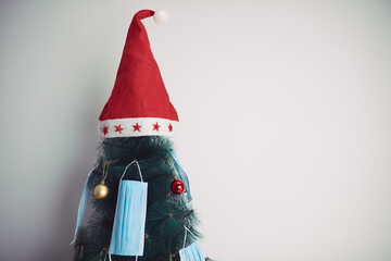 Christmas tree decorated with surgical masks - illustration to virus pandemic 2020 / 2021 social...