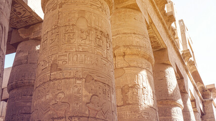 Giant columns of Karnak temple overscale architect with beautiful painting and hieroglyphic carving details