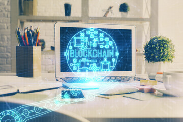 Multi exposure of blockchain and crypto economy theme hologram and table with computer background....