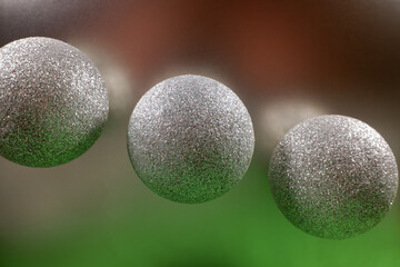 beautiful Christmas balls of silver color on a green-silver background. New year's holiday decorations