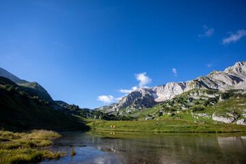 Fototapeta na wymiar Mountain lake. Mountain peaks are reflected in the water