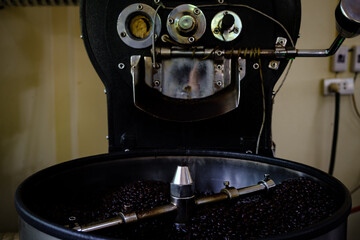 Fresh Coffee Beans - roasted 100% Arabica coffee beans falling into a spinning cooler professional...