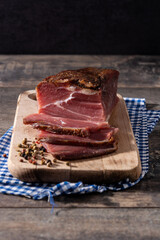 Dried and smoked meat on wooden table. 