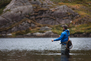 Man flyfishing in lake
