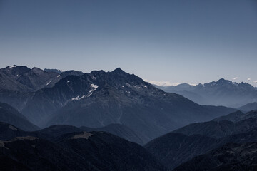 Fototapeta na wymiar View of endless mountain ranges in the haze of the day