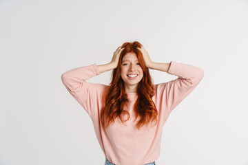 Fototapeta premium Ginger beautiful happy girl grabbing her head and smiling