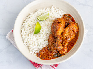 Indian Chicken Leg Curry with Rice in a Bowl, Traditional Indian Meal