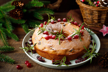 Christmas cranberry fruit cake with decorations on wooden background