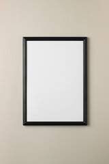 Empty black picture frame white background on beige backdrop