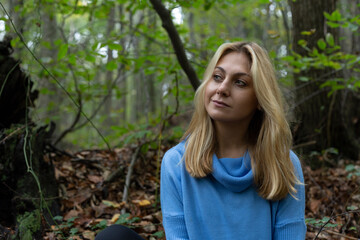 Beautiful woman alone in the forest in autumn