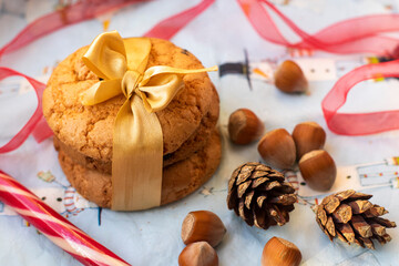 Christmas cookies with gold ribbon, cones and nuts. Festive decoration