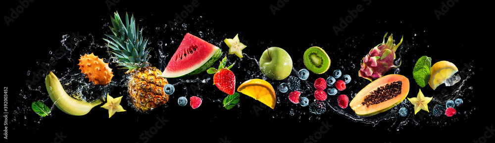 Wall mural assortment of fresh fruits and water splashes on panoramic background