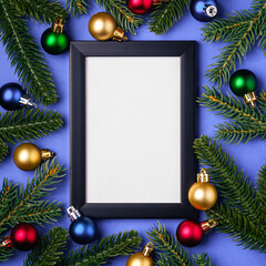 Fototapeta na wymiar Christmas composition with empty picture frame. Colorful ornament and fir branches decorations. Mock up greetings card template