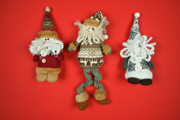 Christmas greeting card with noel christmas gnomes on red surface with copy space. Top view