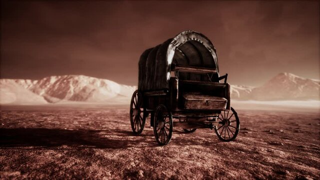 canvas covered retro wagon in desert at sunset