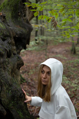 Beautiful woman alone in the forest in autumn