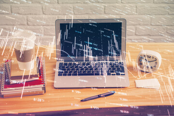 Multi exposure of graph and financial info and work space with computer background. Concept of international online trading.