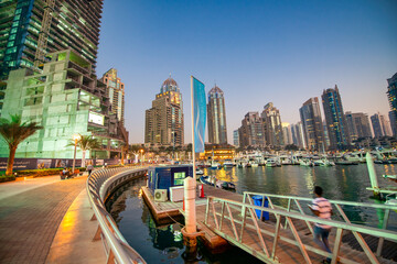 DUBAI, UAE - DECEMBER 6, 2016: Dubai Marina at sunset, city promenade. Skyscrapers along the canals