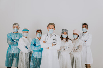 Team of doctors and nurses wearing disposable protection suits and face masks for fighting Covid-19...
