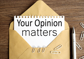 YOUR OPINION MATTERS, text ON WHITE paper on envelope on wood background