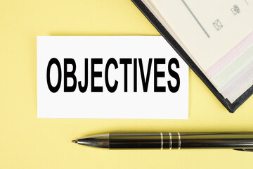 objectives, text on white paper over yellow background