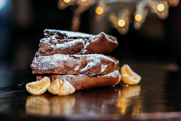 christmas  chocolate cake in the darkk background wit mansarins around