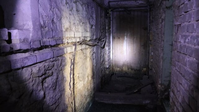 Flashlight in Scary underground, basement. Old abandoned warehouses in a dungeons.