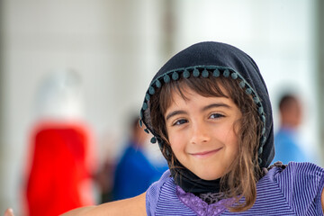 Happy caucasian young tourist visiting Sheikh Zayed Mosque in Abu Dhabi, UAE