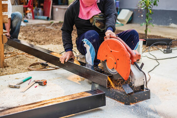 A barber is cutting steel with an electric iron cutter.