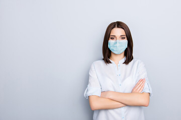 Photo portrait of girl with crossed arms wearing blue face mask isolated on white colored background with blank space