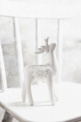 White deer on a white chair. New year concept.