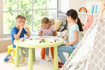 Little children painting rainbow  during Covid-19 quarantine at home