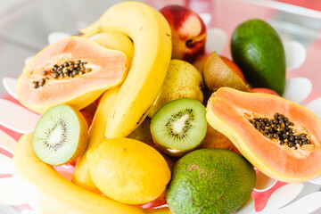 Plate of mixed exotic fruit on the kitchen table