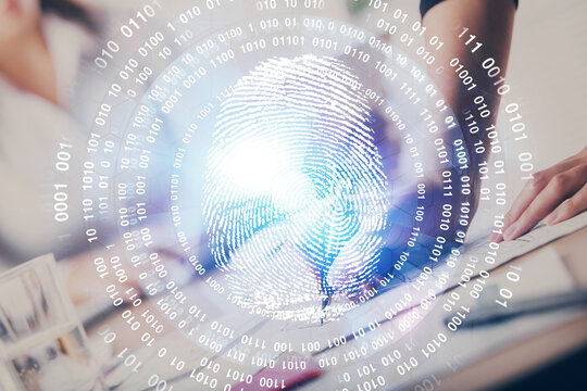 Blue fingerprint hologram over woman's hands taking notes background. Concept of protection. Double exposure