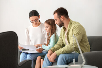 Female psychologist working with family in office