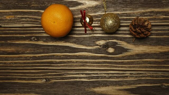 Stop motion animation. Mandarin duck eats Christmas tree toys on a wooden background. Bump, bell, ball, gift, drum