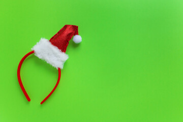 christmas headband red santa hat on green background copy space