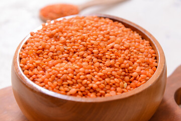 Bowl with raw lentils on table, closeup