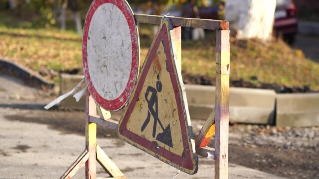 Close up of sign of road work to inform traffic participants about carrying out repairs on road. Concept of careful and attentive driving.