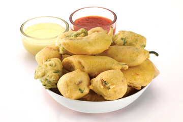 Indian Street Fried Food Pakora Also Know as Pakoda, Bhajiya, Bhajia, Methi Gota, Kanda Bhaji, Pyaz Pakoda, Fried Chillies, Onion Wada, potato vada, aloo Bhaji or fritter, Served with Chutney.