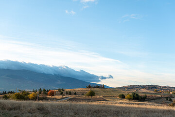 Obraz premium Autumn landscape golden hillside sunny day with storm approaching from left side in rural Bulgaria