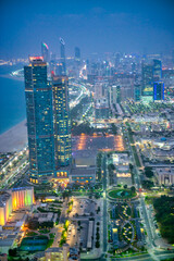 Fototapeta premium Abu Dhabi skyline along Corniche Road at night, UAE