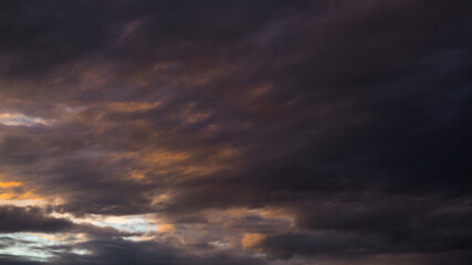 Beau ciel orangé pendant que le soleil se couche.  Le temps est lourd, presque orageux